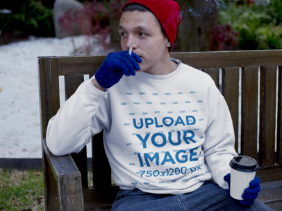 Guy with a Coffee and Smoking Wearing a Crewneck Mockup in the Snow