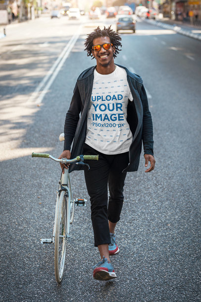 T-Shirt Mockup of a Stylish Man with a Bike on the Street