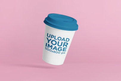 Mockup of a Coffee Cup Floating Against a Plain Color Backdrop