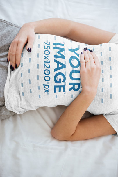 T-Shirt Mockup of a Pregnant Woman Lying on Her Bed