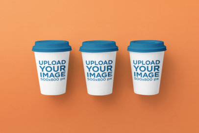 Mockup of Three Coffee Cups Against a Plain Backdrop