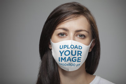 Mockup of a Long-Haired Woman Wearing a Customizable Face Mask 
