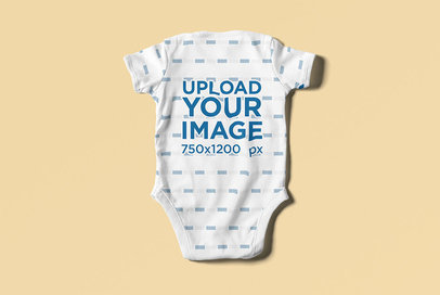 Baby Onesie Mockup Featuring the Back View of the Garment on a Solid Surface