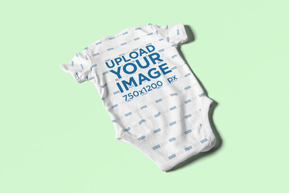Mockup of a Baby Onesie Laid on a Flat Surface 4587-el1