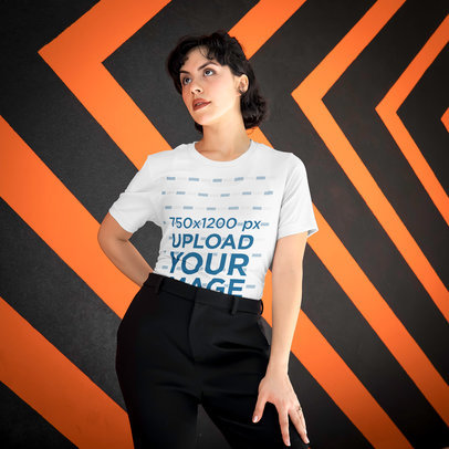 T-Shirt Mockup of a Serious Woman Posing Against a Patterned Wall 