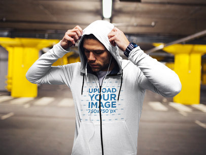 Mockup of a Man Wearing a Hoodie in a Parking Lot 37612-el2