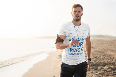 T-Shirt Mockup of a Man Jogging at the Beach