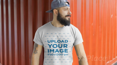 T-Shirt Video of a Bearded Man Posing in Front of a Metal Container