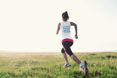 Back View Mockup of a Woman with a Tank Top Running at a Field 