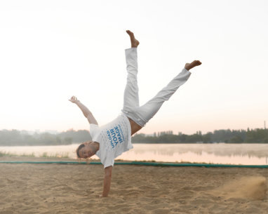 T-Shirt Mockup of a Man Doing a One Arm Handstand