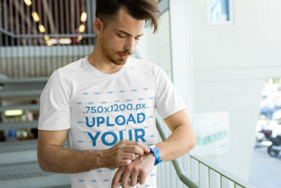 Activewear T-Shirt Mockup of a Man at a Gym Checking the Hour