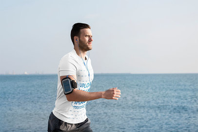 T-Shirt Mockup of a Serious Man Running in the Beach