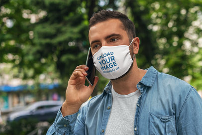 Face Mask Mockup Featuring a Man on His Phone 