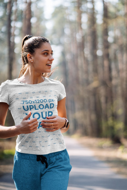 Heather T-Shirt Mockup of a Woman Running in the Woods