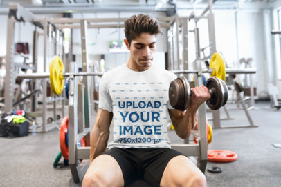T-Shirt Mockup of a Man Doing Bicep Curls in the Gym