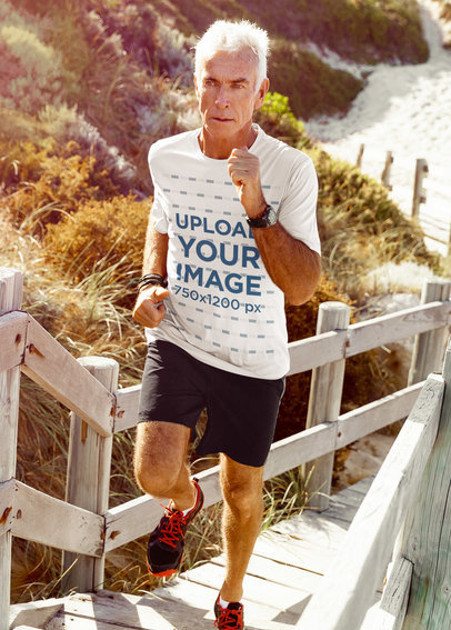 Activewear T-Shirt Mockup of a Senior Man Running Outside
