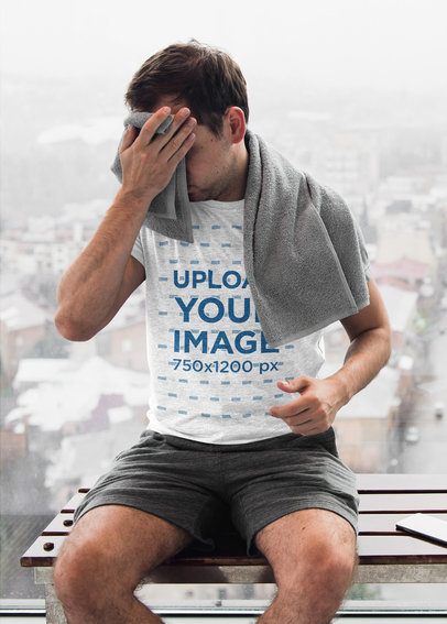 Mockup of a Man with a Heather Shirt Wiping His Face at a Gym