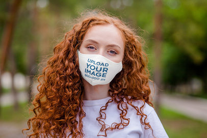 Mockup of a Woman With Curly Hair Wearing a Face Mask 