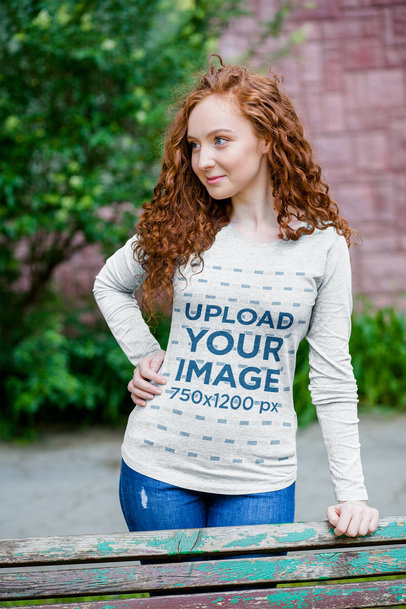 Heather Long Sleeve Tee Mockup Featuring a Curly-Haired Woman Posing by a Bench 