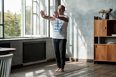 T-Shirt Mockup of a Man Practicing Tai Chi at Home