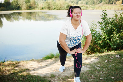 Activewear Mockup of a Woman with a Plus Size T-Shirt Stretching by a Lake
