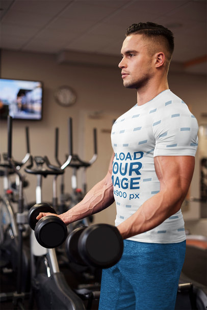 Sublimated Tee Mockup of a Man Doing Bicep Curls at the Gym