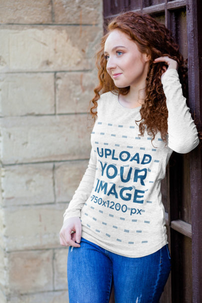 Mockup of a Woman Wearing a Heather Long Sleeve Tee and Posing by an Old Door 4729-el1