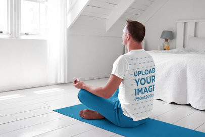 Back-View T-Shirt Mockup of a Man Meditating in His Room
