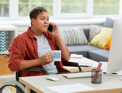 Mockup of a Woman with an 11 oz Mug Working from Home 