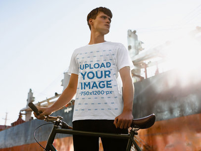 T-Shirt Mockup of a Man with His Bike in the City
