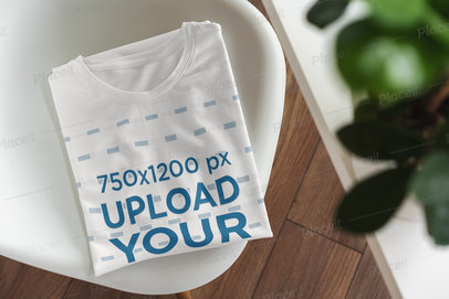 Mockup Featuring a Folded T-Shirt Placed on a Chair 