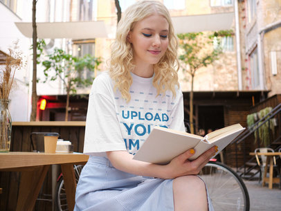 T-Shirt Mockup of a Smiling Woman Reading a Book