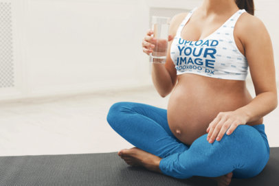 Sports Bra Mockup of a Pregnant Woman Holding a Glass of Water 