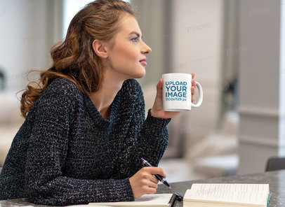 Mockup of a Woman with an 11 oz Coffee Mug Reading in the Kitchen 