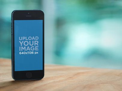 Mockup of an iPhone 5s Standing on a Table