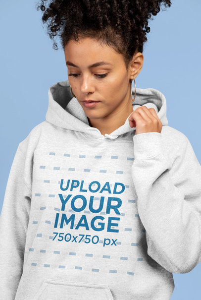 Mockup of a Woman Wearing a Heathered Hoodie in a Studio