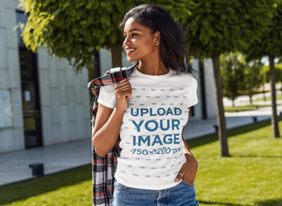 Mockup Featuring a Happy Woman Wearing a Crew Neck T-Shirt at a Museum's Garden 
