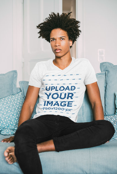 V-Neck Tee Mockup of a Serious Man Sitting on a Blue Couch 35193-r-el2