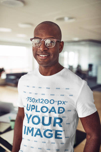T-Shirt Mockup of a Man Wearing Glasses at an Office