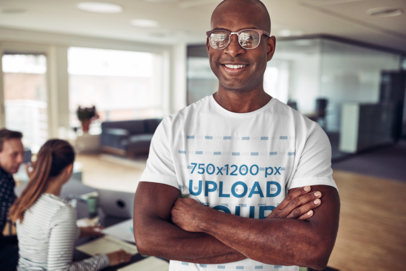 Mockup of a Smiling Man Wearing a Tee Inside an Office