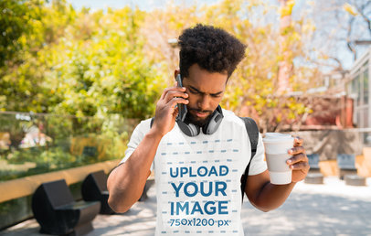 T-Shirt Mockup of a Serious Man Talking on the Phone on His Way to School