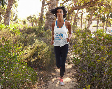 Mockup of a Woman with a Loose Tank Top Running in the Woods 39015-r-el2