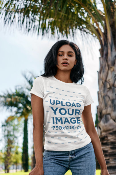 T-Shirt Mockup of a Serious Woman Posing by a Palm Tree 