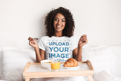 T-Shirt Mockup of a Woman Eating Breakfast in Bed
