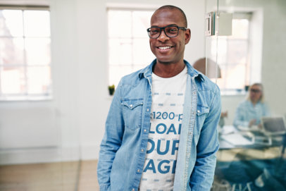 T-Shirt Mockup Featuring a Smiling Man with Glasses and Denim Garment