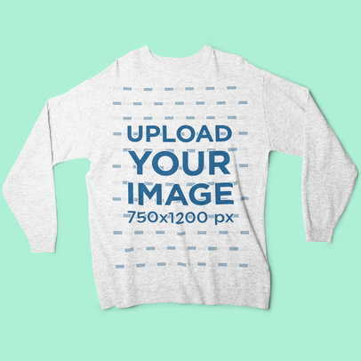 Mockup of a Heather Sweatshirt Lying on a Flat Surface