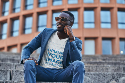 Mockup of a Fashionable Man Posing on an Urban Stairway with a V-Neck Tee