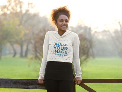 Mockup of a Happy Woman Wearing a Heathered Crop Top Hoodie 