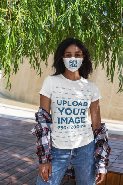 T-Shirt Mockup of a Woman Wearing a Face Mask Under a Tree