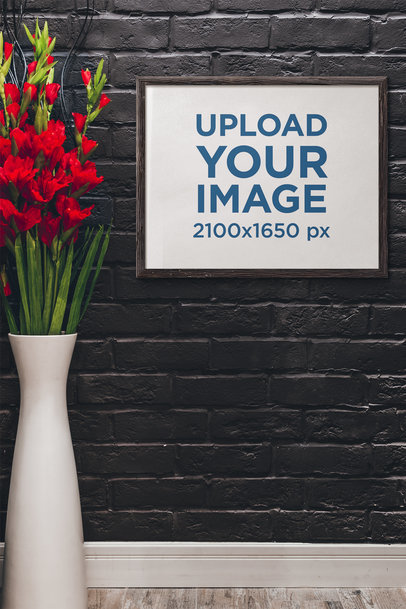 Mockup Featuring an Art Print Placed by a Big Vase With Red Flowers 